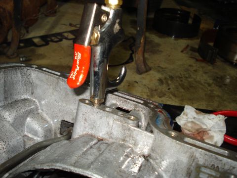 1984 Ford Bronco - Close-up of an air tool being used to clean a transmission housing, with "Blue-Point" visible on the tool.