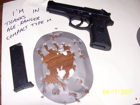 2000 Nissan Xterra - A pistol and magazine are shown next to a target with numerous bullet impacts.