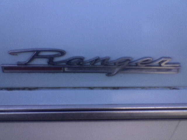 Chrome Ford Ranger emblem on a light blue surface