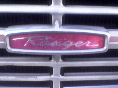 1969 Ford F-250 - Close-up of the 'Ranger' emblem on the grille of a 1969 Ford F-250 truck.