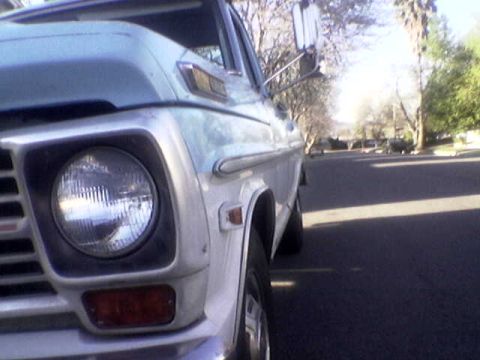 1969 Ford F-250 - The front corner of a vintage pickup truck is shown parked on a residential street.