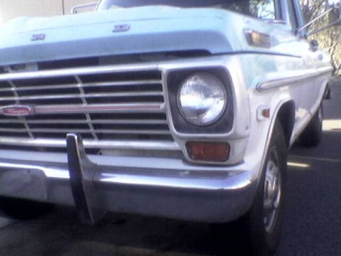 1969 Ford F-250 - Front view of a white Ford truck, focusing on the grille and headlight assembly.