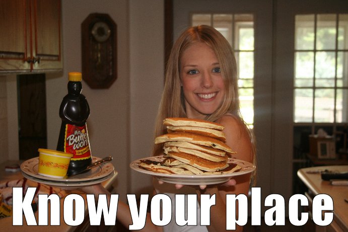 Woman holding a stack of pancakes and a bottle of syrup