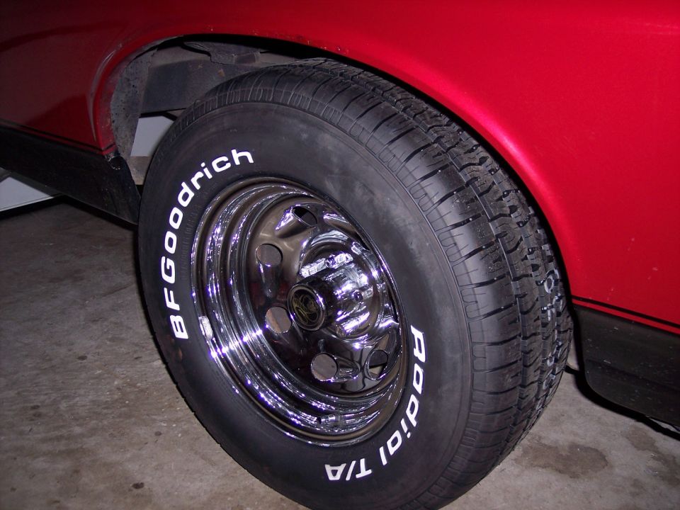 BFGoodrich Radial T/A tire on chrome wheel, part of a red vehicle