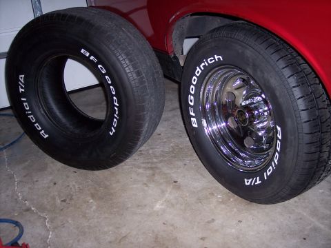 1972 Ford Ranchero - A spare tire sits beside a mounted wheel on a red vehicle, possibly classic, vehicle.
