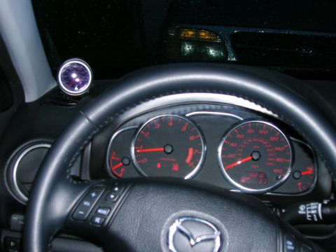 1994 Ford Probe - Interior view of a car's dashboard, gauges and a steering wheel with controls. A boost gauge is mounted on the dash.