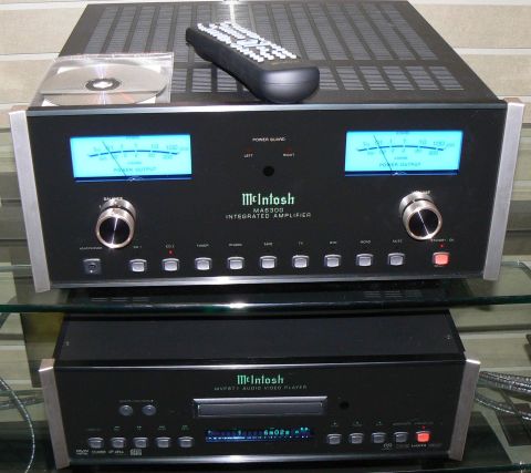 2006 Ford E350 - A McIntosh MA8300 integrated amplifier sits above a McIntosh MVP871 audio video player, with a remote and CD on top.