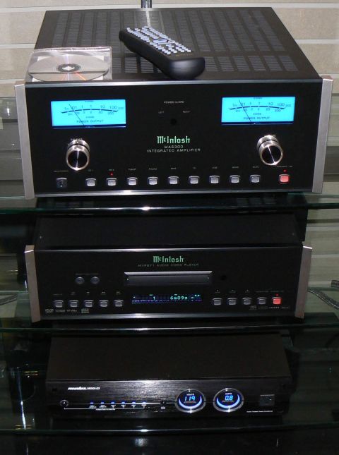 2006 Ford E350 - A stack of McIntosh audio equipment, including an integrated amplifier and an audio video player, is displayed on glass shelves.