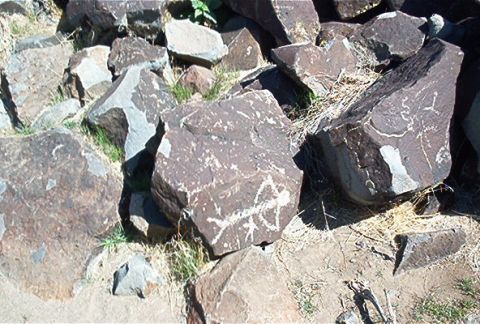 1986 Ford Bronco - Petroglyphs etched into rocks in an outdoor setting, showing ancient carvings.