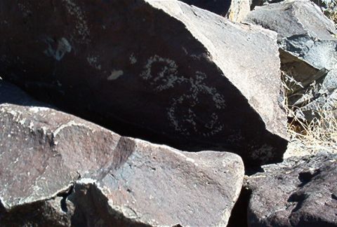 1986 Ford Bronco - Ancient petroglyphs are visible on large rocks, suggesting a historical site.