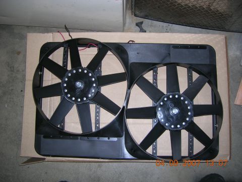 1996 Ford Bronco - A pair of electric cooling fans are shown mounted on a shroud, likely for an automotive application.