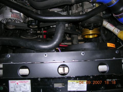 1996 Ford Bronco - Close-up view of a vehicle's engine bay, showing various components and a date stamp.