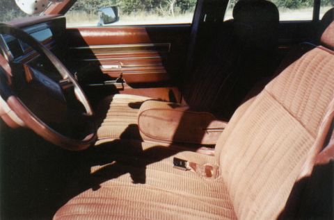 1986 Ford Crown Victoria LTD - Interior view of a 1986 Ford Crown Victoria LTD, highlighting the tan striped upholstery and brown trim.