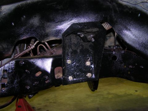 1993 Ford Bronco - Underside view of a vehicle's frame, showing suspension mounting points and hardware.