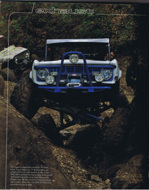 1971 Ford Bronco - Front view of a 1971 Ford Bronco driving on a dirt path.