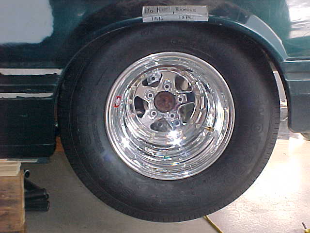 1992 Ford Mustang rear wheel with chrome five-star rim and drag radial tire