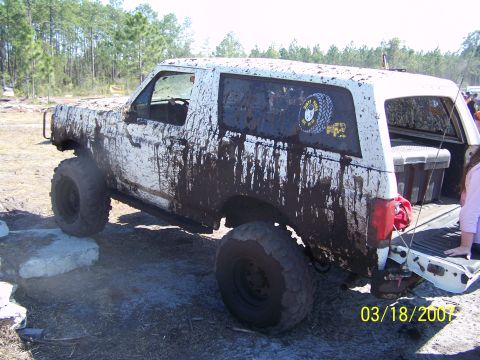 1989 Ford Bronco - This 1989 Ford Bronco is heavily covered in mud, suggesting it has been used for off-roading.