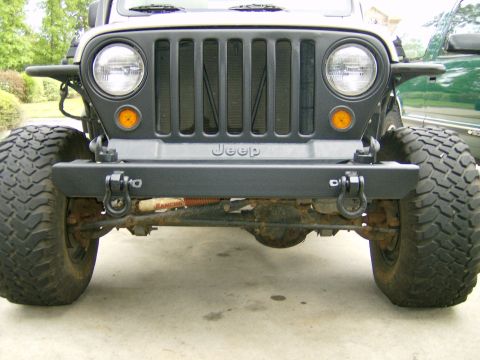 2004 Jeep Wrangler - Front view of a 2004 Jeep Wrangler with an aftermarket bumper and large tires.