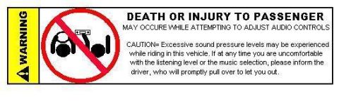 1986 Ford Crown Victoria LTD - This label warns passengers about potential injury from adjusting audio controls and advises them to inform the driver if uncomfortable.