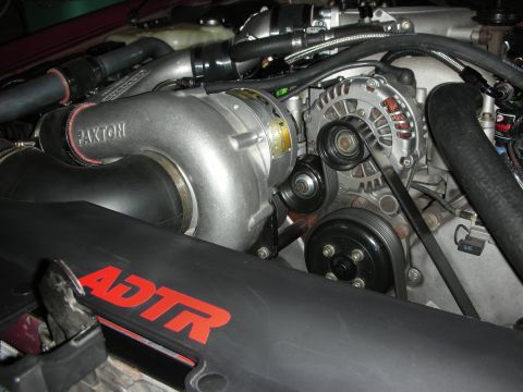 1992 Ford Crown Victoria - Close-up of an engine bay, highlighting a supercharger and other engine components.