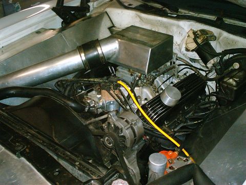 1975 Ford Ranchero - The engine bay features a custom intake system and various engine components.
