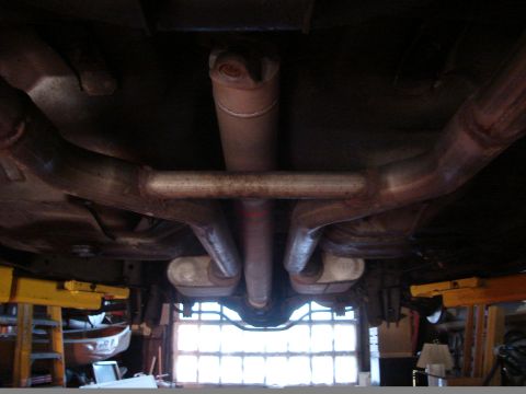 1992 Ford Crown Victoria - Underside view shows the exhaust system and driveshaft of a vehicle.