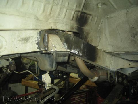 1987 Suzuki Samurai - Close-up view of a modified vehicle frame, likely undergoing suspension work.