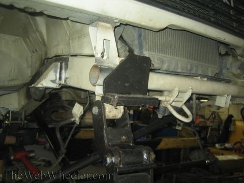 1987 Suzuki Samurai - Close-up view of custom suspension modifications on a vehicle's undercarriage.