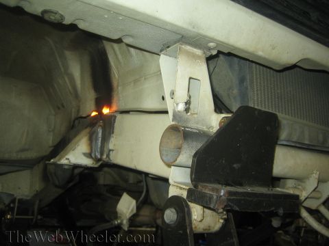 1987 Suzuki Samurai - Frame modification in progress, likely for suspension work, with welding sparks visible.