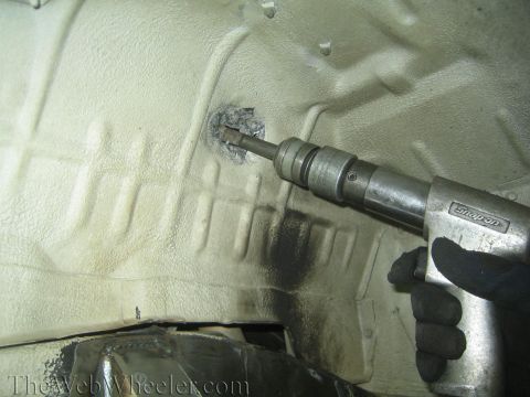 1987 Suzuki Samurai - A pneumatic hammer is used to modify the undercarriage of a vehicle.