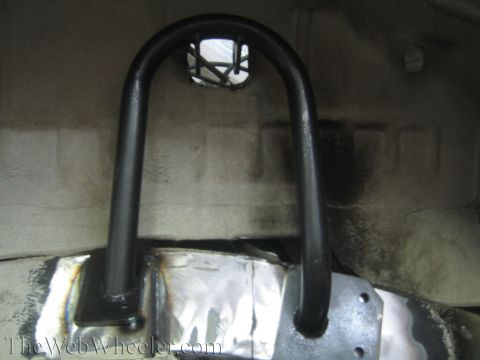 1987 Suzuki Samurai - Custom roll cage tubing is welded to the frame of a vehicle, likely for off-road modification.