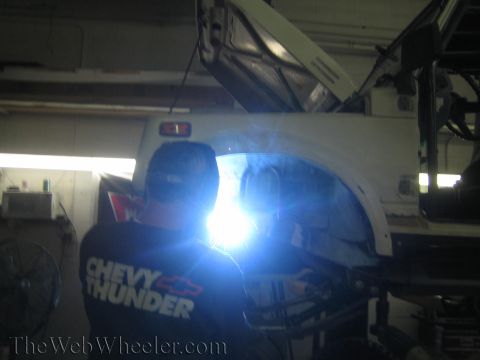 1987 Suzuki Samurai - Welding work being done on the body of a vehicle in a garage.