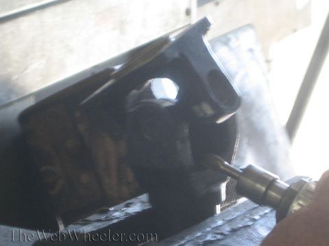 1987 Suzuki Samurai - Close-up of a metal part being worked on with a rotary tool.