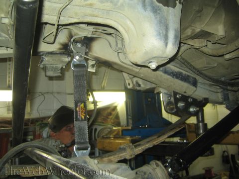 1987 Suzuki Samurai - Close-up of vehicle undercarriage, focusing on suspension modifications and frame components.