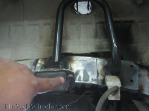 1987 Suzuki Samurai - A person points to a modified section of a vehicle's frame, showing recent welding work.