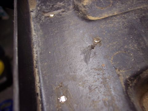 1995 Ford Probe - A close-up view of a car's interior panel shows rivets and textured surface.