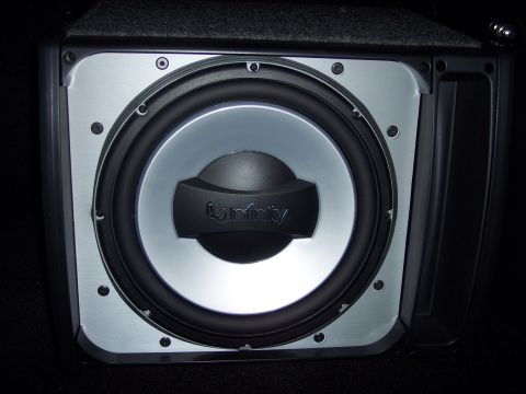 1995 Ford Probe - Close-up of a car subwoofer with the Infinity brand visible on the speaker cone.