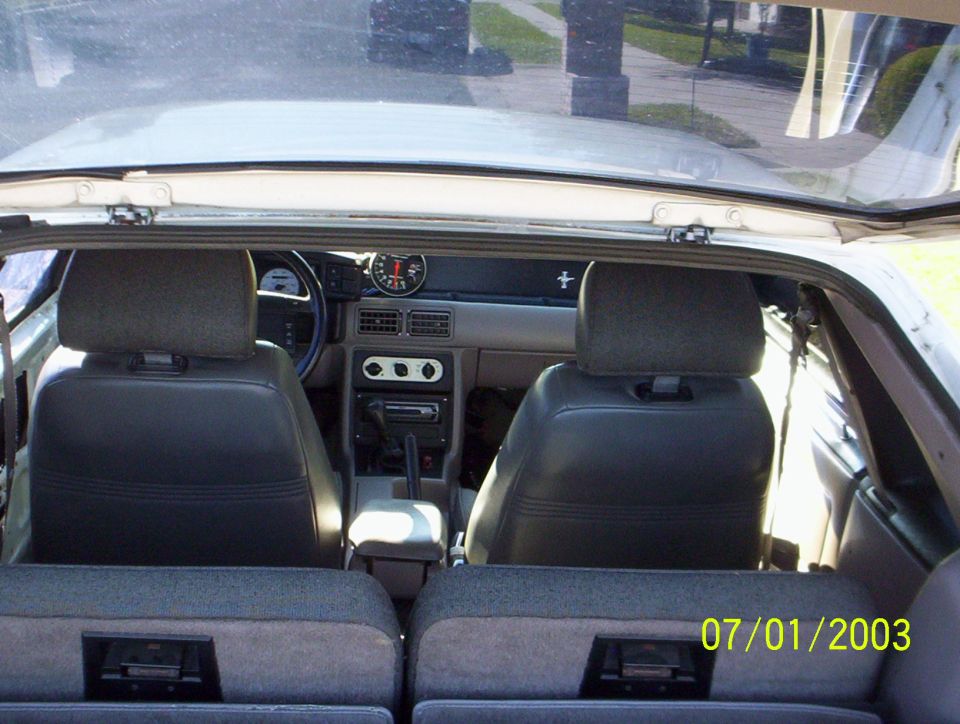 1991 Ford Mustang interior view from rear seats, showing dashboard and gauges
