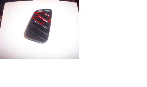1994 Ford Probe - A close-up view of a dark-colored automotive part with red accents.