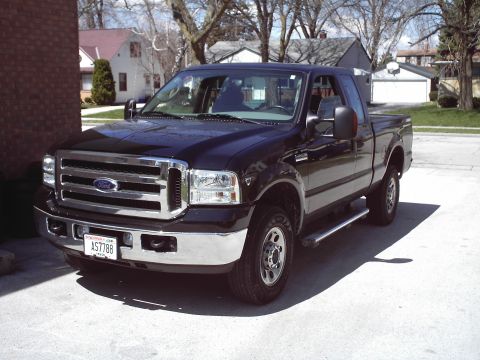 1994 Ford F-250 - This black Ford F-250 truck is parked outside on a sunny day.