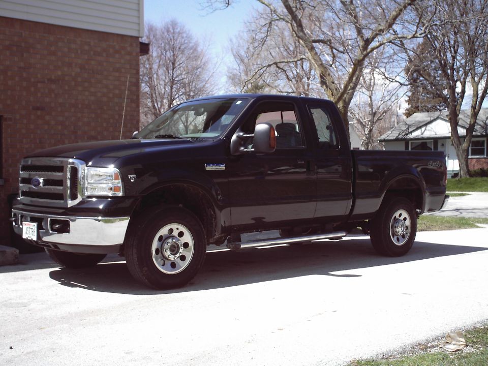 Black pickup truck, 3/4 front view. Grille indicates a 2005 model year