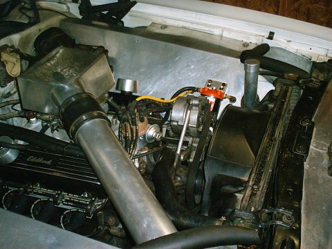 1975 Ford Ranchero - Close-up view of a modified engine bay, showing various components and wiring.