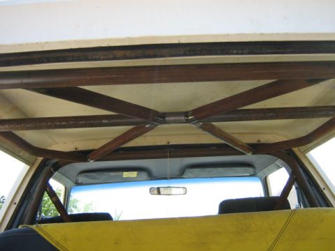 1986 Ford Bronco - A custom-built roll cage is installed inside the vehicle, obscuring the view of the rear seats and headliner.