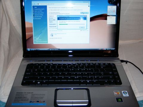 2000 Ford Crown Victoria - Laptop computer running Windows Vista shows a completed DirectX assessment and a calendar widget.