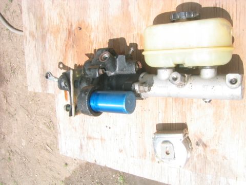 1973 Ford F-100 - A hydroboost brake booster with blue accumulator canister bolted to an aluminum master cylinder with a translucent yellowed plastic reservo…