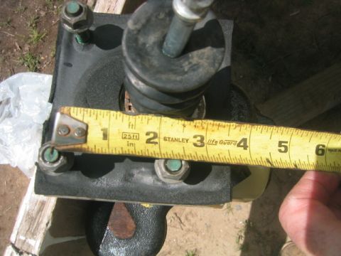 1973 Ford F-100 - A close-up view shows a brake booster and master cylinder assembly being measured with a yellow tape measure.