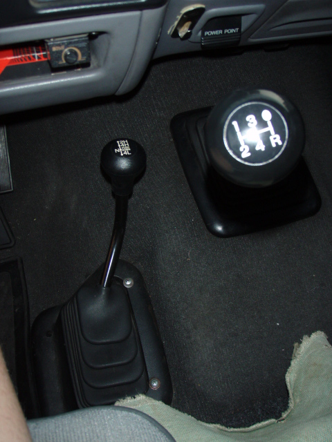 1995 Ford F-150 - The interior shows a manual transmission shifter and a separate transfer case shifter with 2H, 4H, N, and 4L positions.