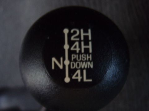 1995 Ford F-150 - Transfer case shifter shows 2H, 4H, N, PUSH DOWN, and 4L positions.