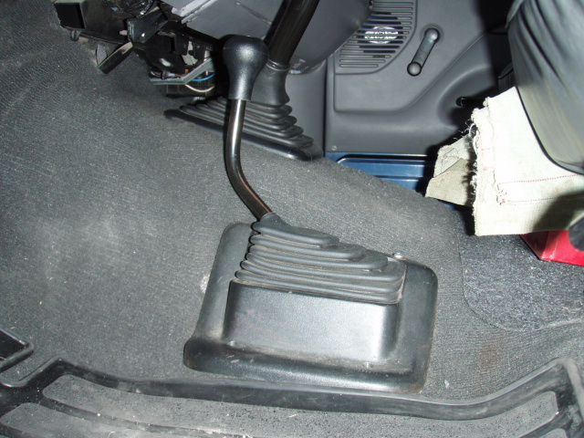 Floor-mounted manual transfer case shift lever with rubber boot in a truck