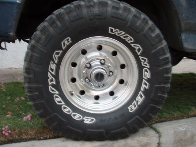 Goodyear Wrangler tire on a polished aluminum wheel mounted on a truck